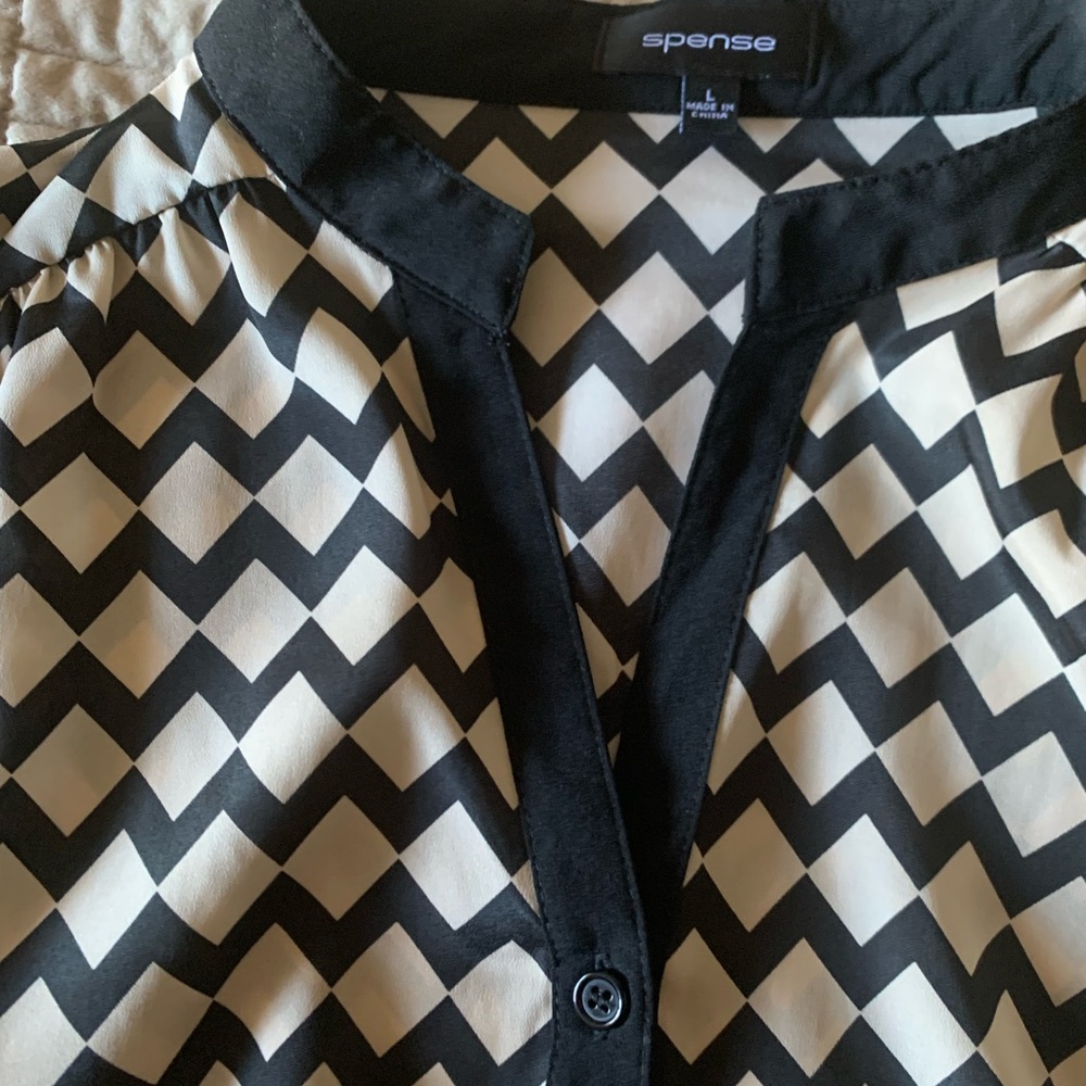 Ladies top cream color with fun zigzag black pattern.